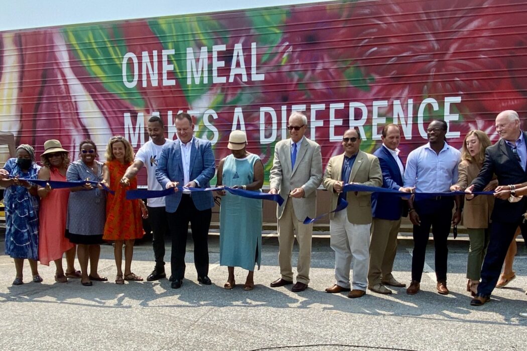 IPHI team and partners getting ready to cut a ribbon to reveal Prince George's County, Maryland's cold food storage trailer.