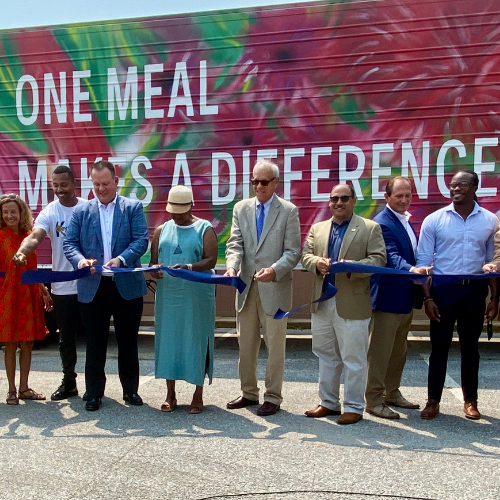 IPHI team and partners getting ready to cut a ribbon to reveal Prince George's County, Maryland's cold food storage trailer.